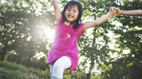 Little Asian girl playing in the park